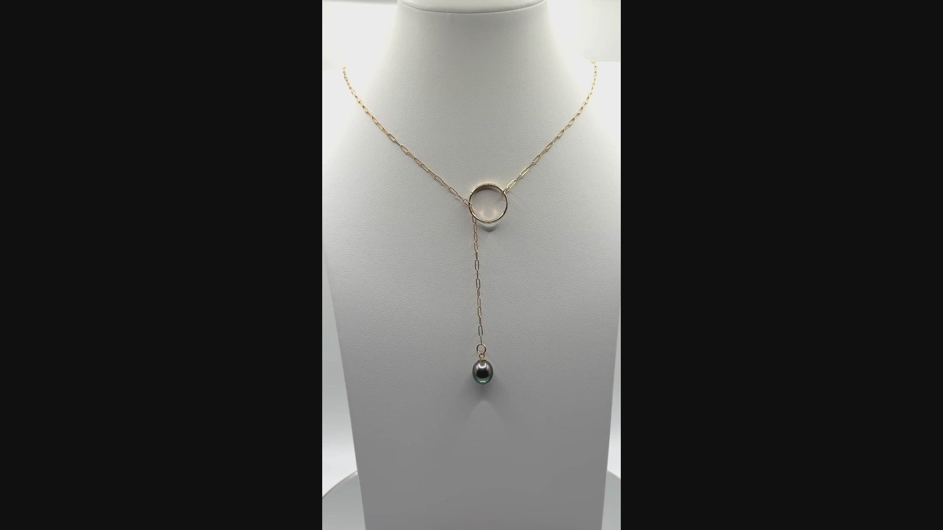 Video showing gold chain lariat necklace with Tahitian pearl rotating to display all angles of the baroque pearl and chain construction