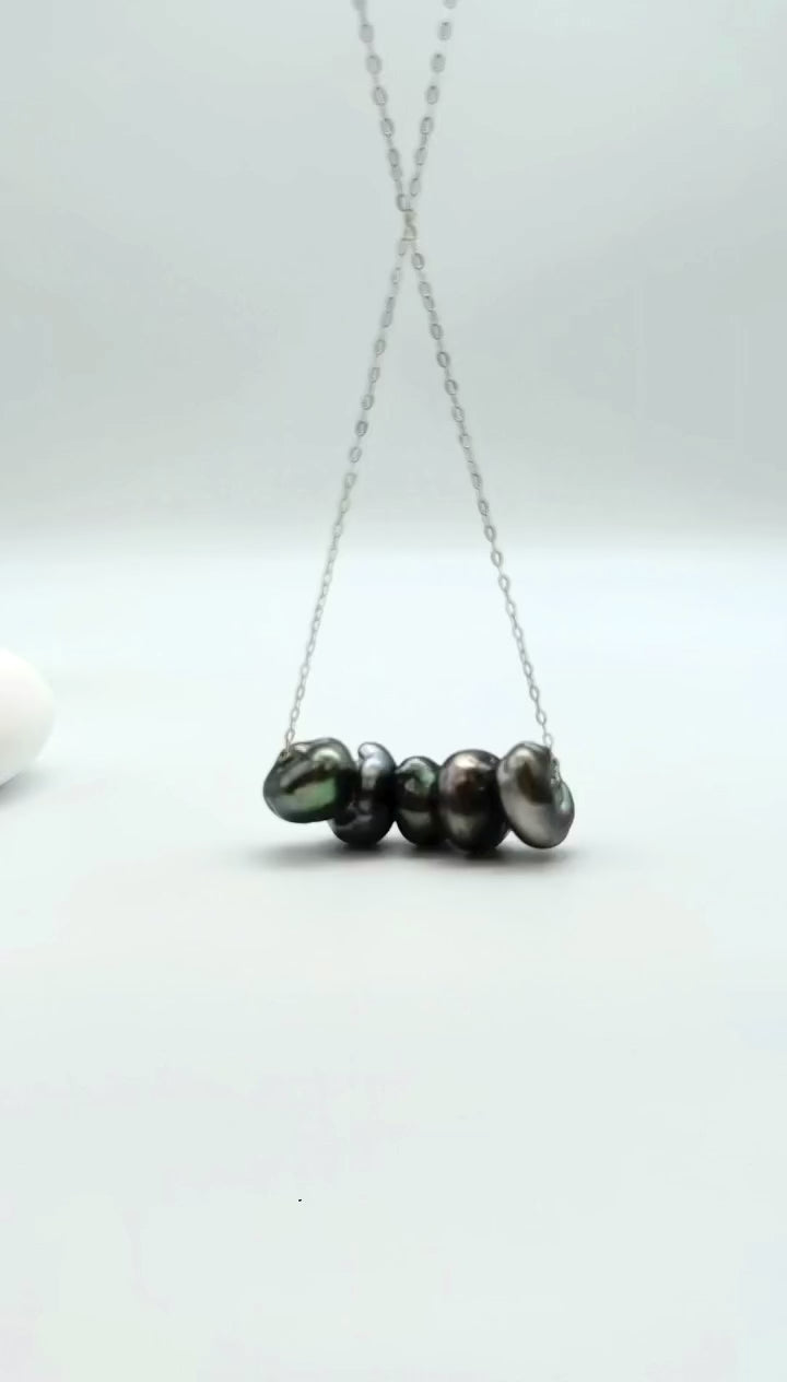 Video showing natural movement of the Large Tahitian Keshi 5-pearl floating necklace suspended in the air