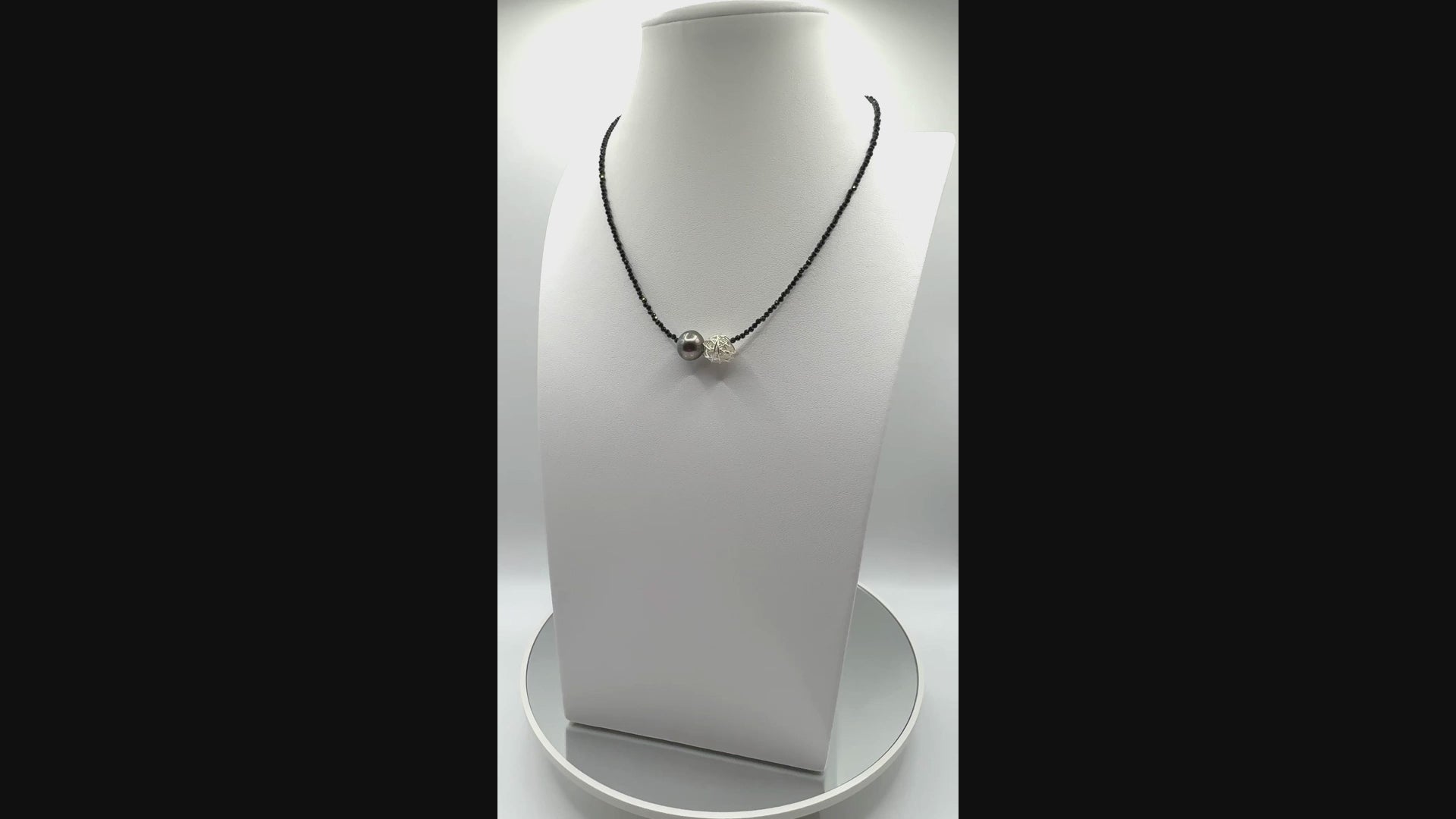 Video showing Tahitian pearl choker on a white bust rotating to display all angles of the baroque pearl and black spinel beads