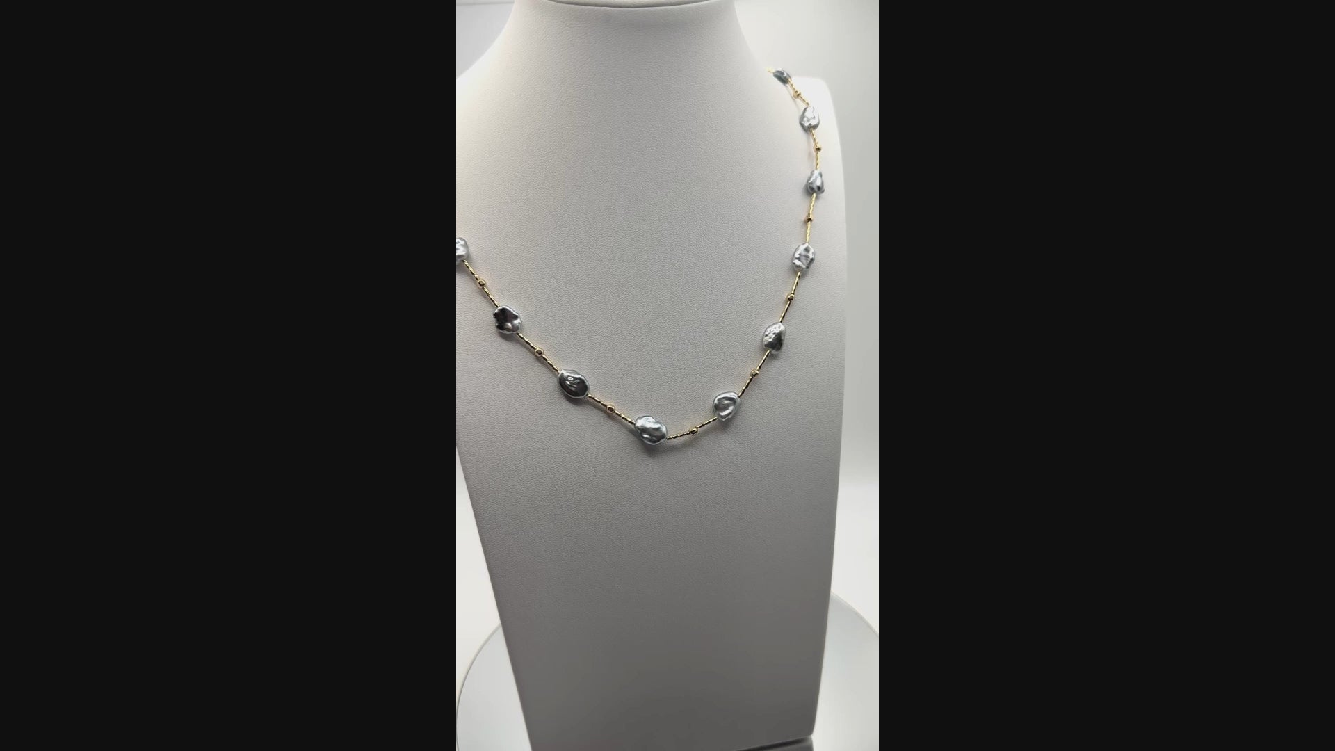 Video showing blue Tahitian Keshi pearl necklace in motion, capturing lustre and gold-filled bead design.