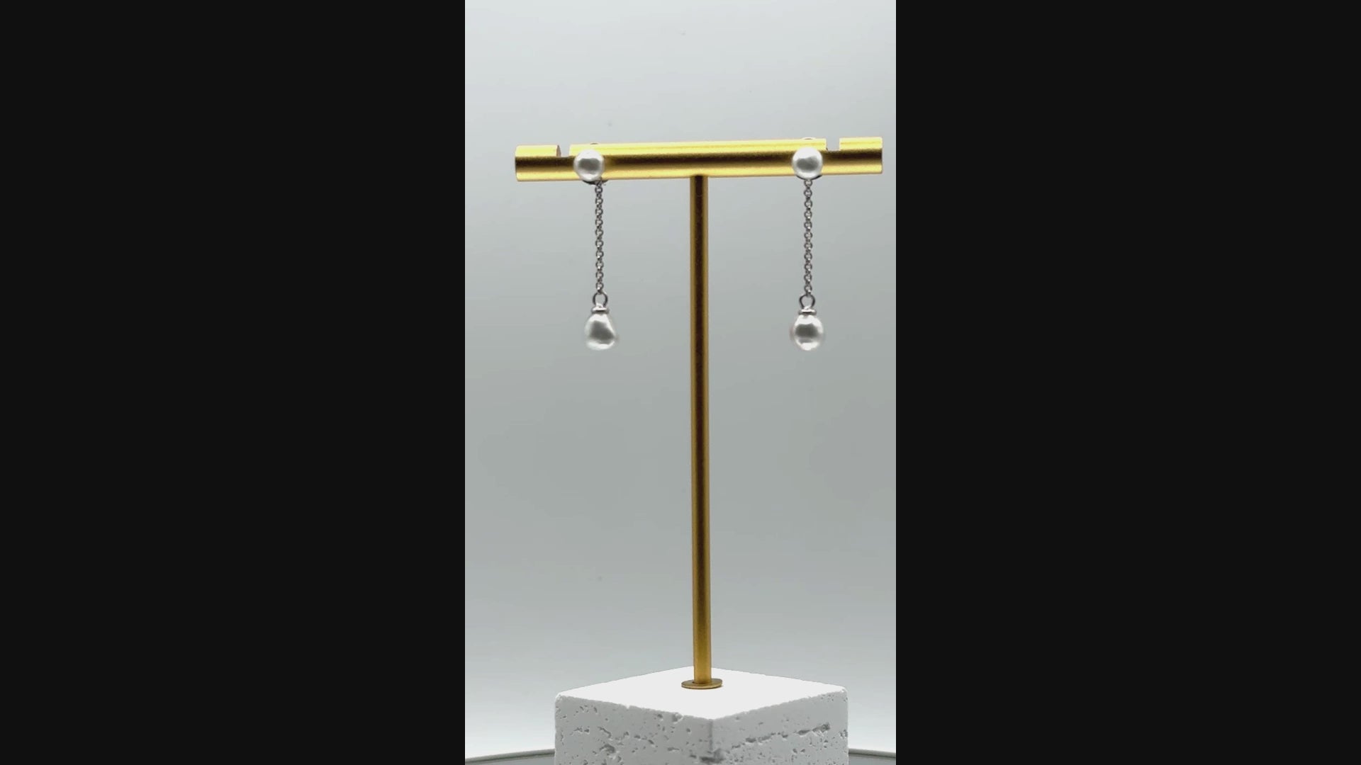 Video showing sterling silver earrings with white South Sea keshi pearls rotating to display all angles of the baroque pearls and versatile styling options