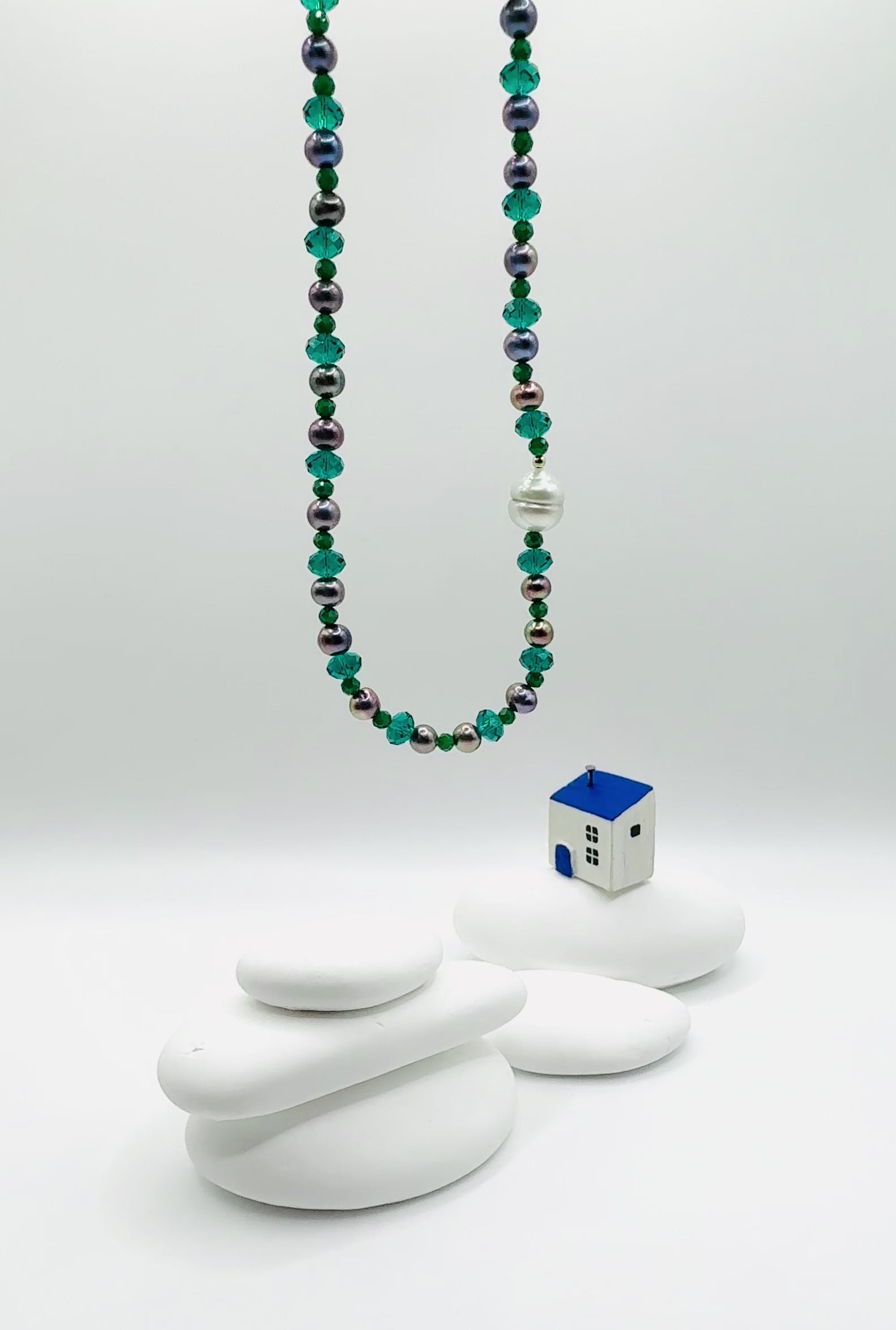 Video showing choker suspended in air displaying movement and lustre of white South Sea baroque pearl with purple freshwater pearls