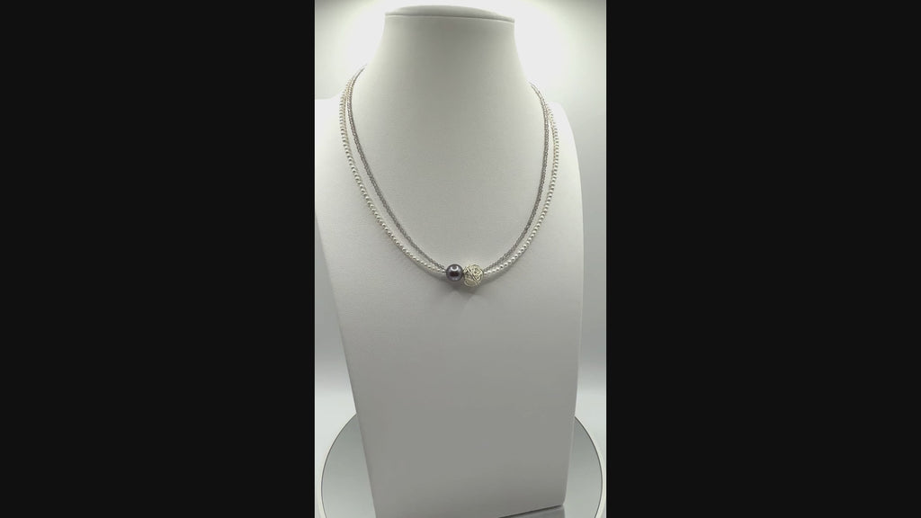 Video showing elegant choker with Tahitian baroque pearl, silver wire-wrapped bead, and white seed pearls rotating to display all angles of the central elements and delicate construction